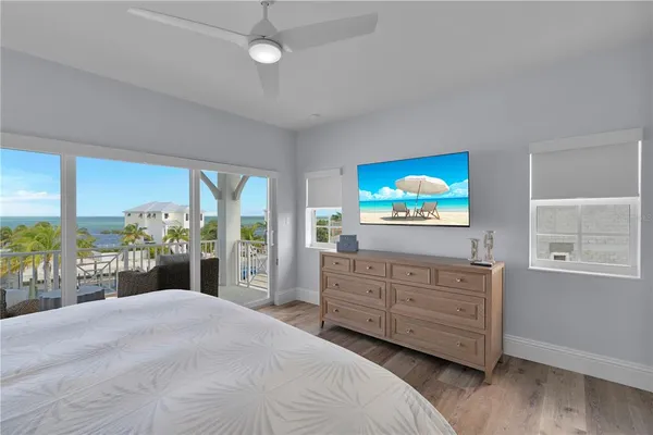 a bedroom with a bed and a lamp on dresser
