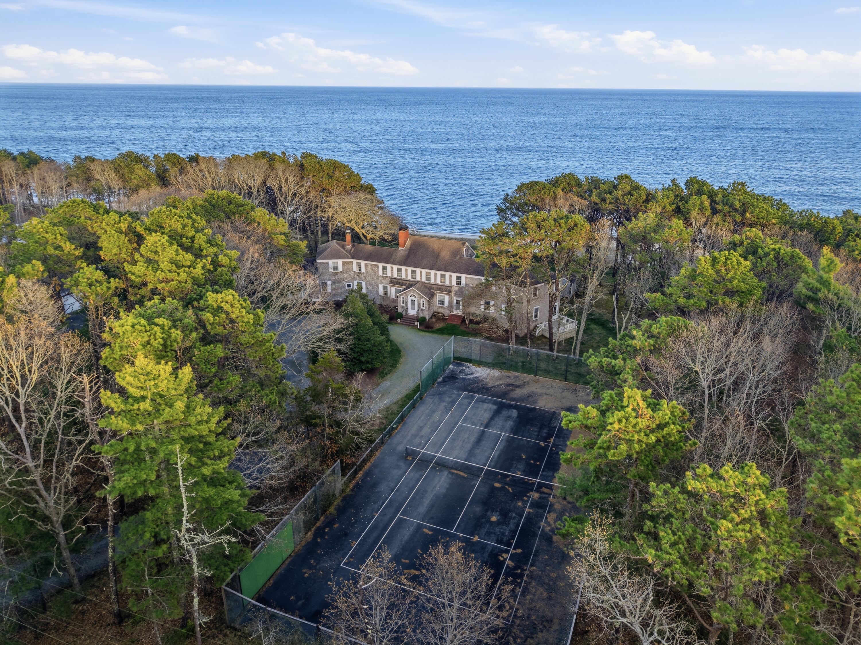 190 Vineyard Road Cotuit, MA 02635 - Photo 11 of 41 a view of a houses with a yard and a wooden fence