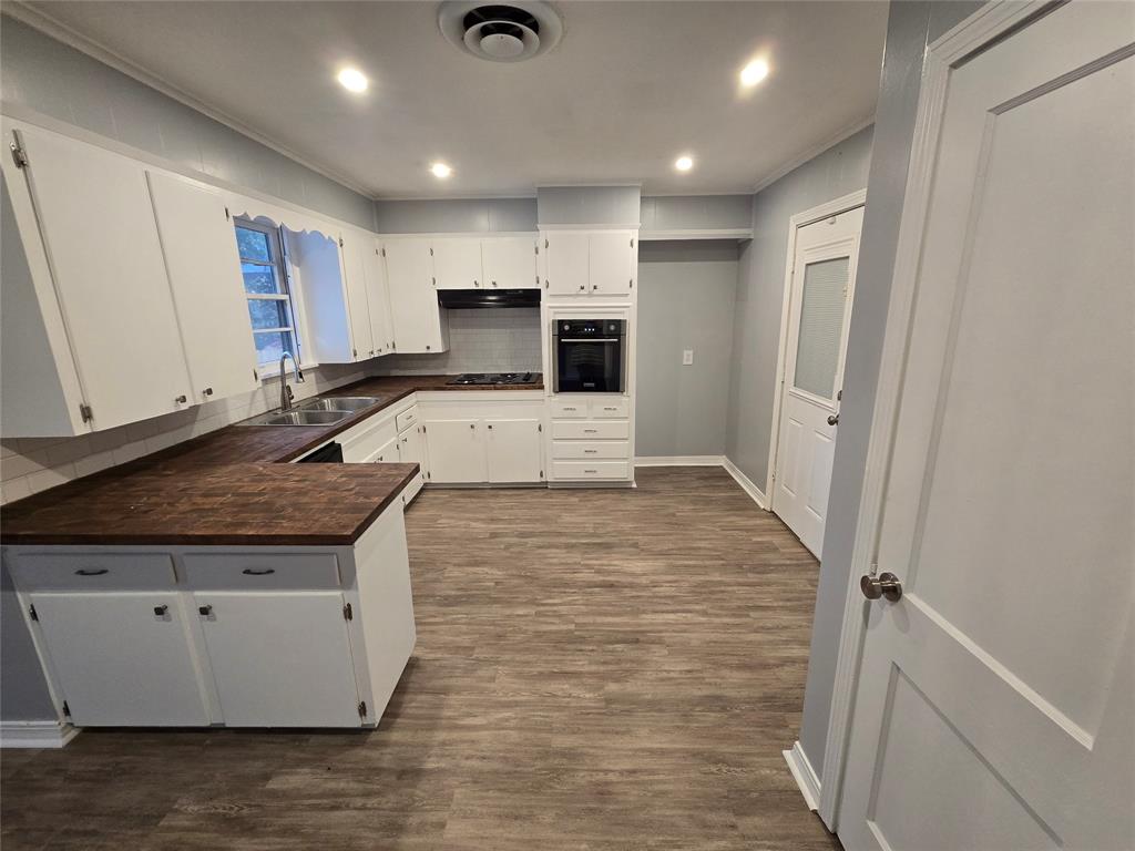 233 Roma Drive Shreveport, LA 71105 - Photo 3 of 12 Kitchen featuring dark countertops, recessed lighting, tasteful backsplash, white cabinets, and black appliances