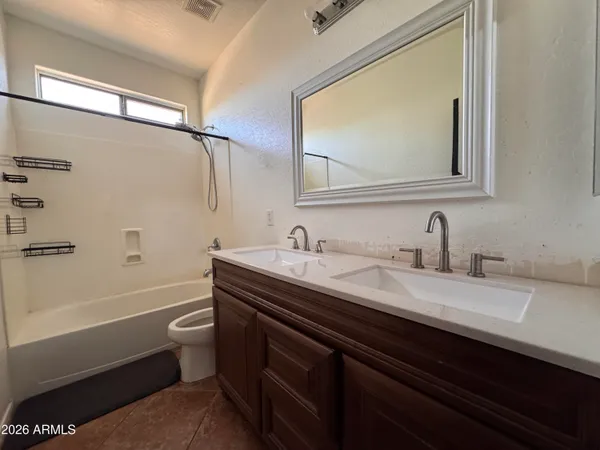 a view of a house with backyard and a tree
