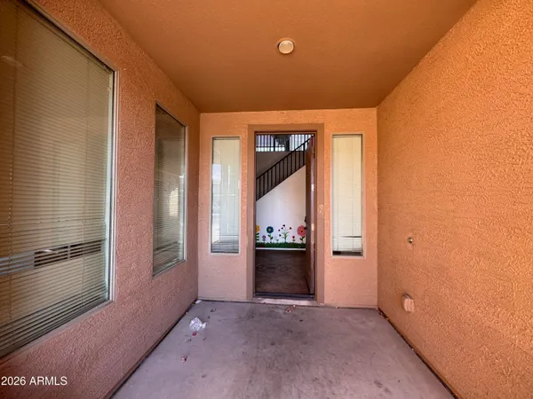 a view of staircase with railing and a rug