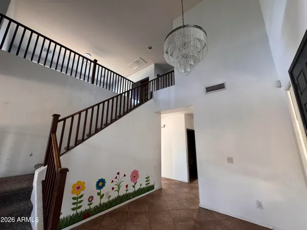a view of a livingroom with a staircase and a ceiling fan