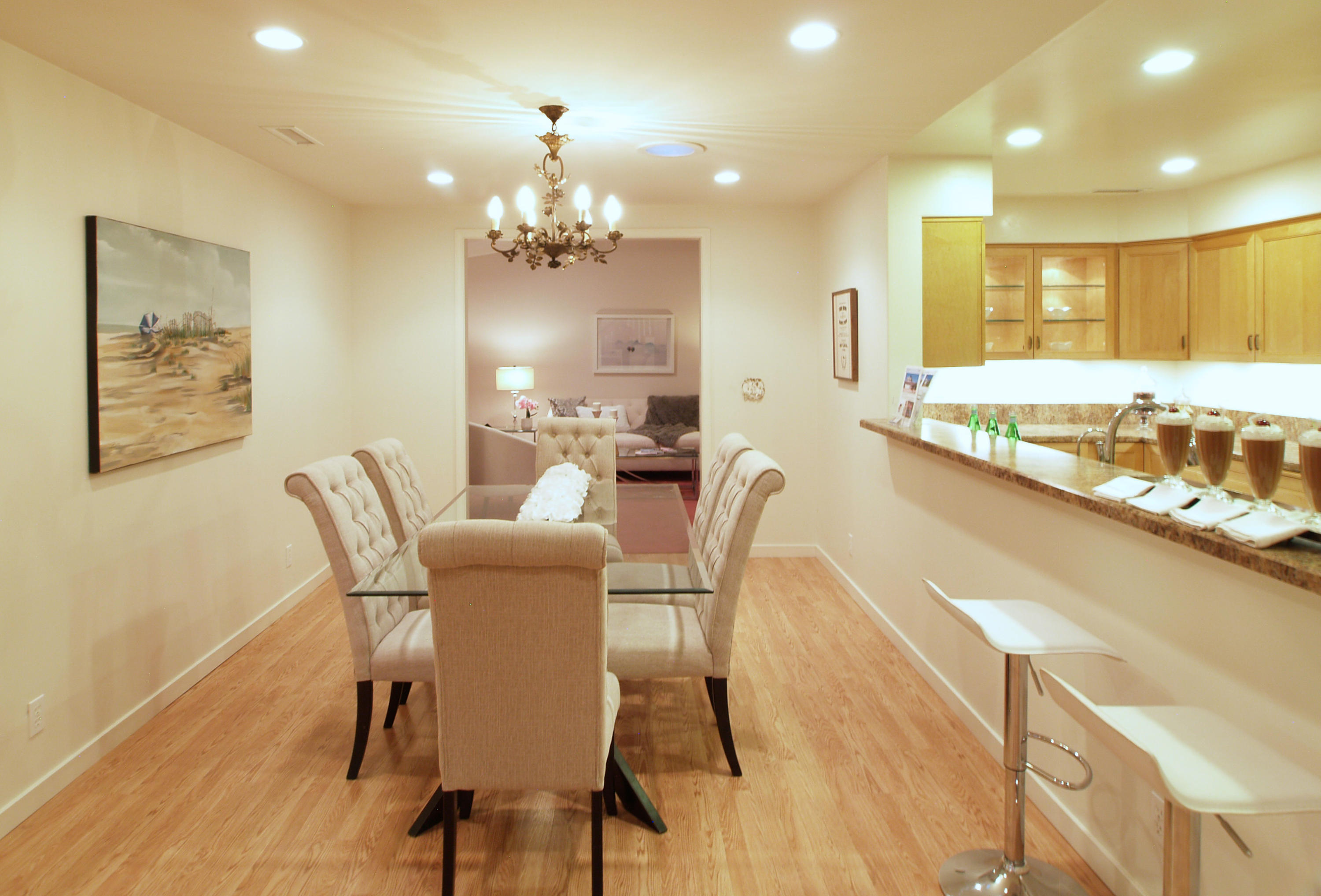 1472 Eucalyptus Street Carpinteria, CA 93013 - Photo 6 of 18 a dining room with furniture a chandelier and wooden floor