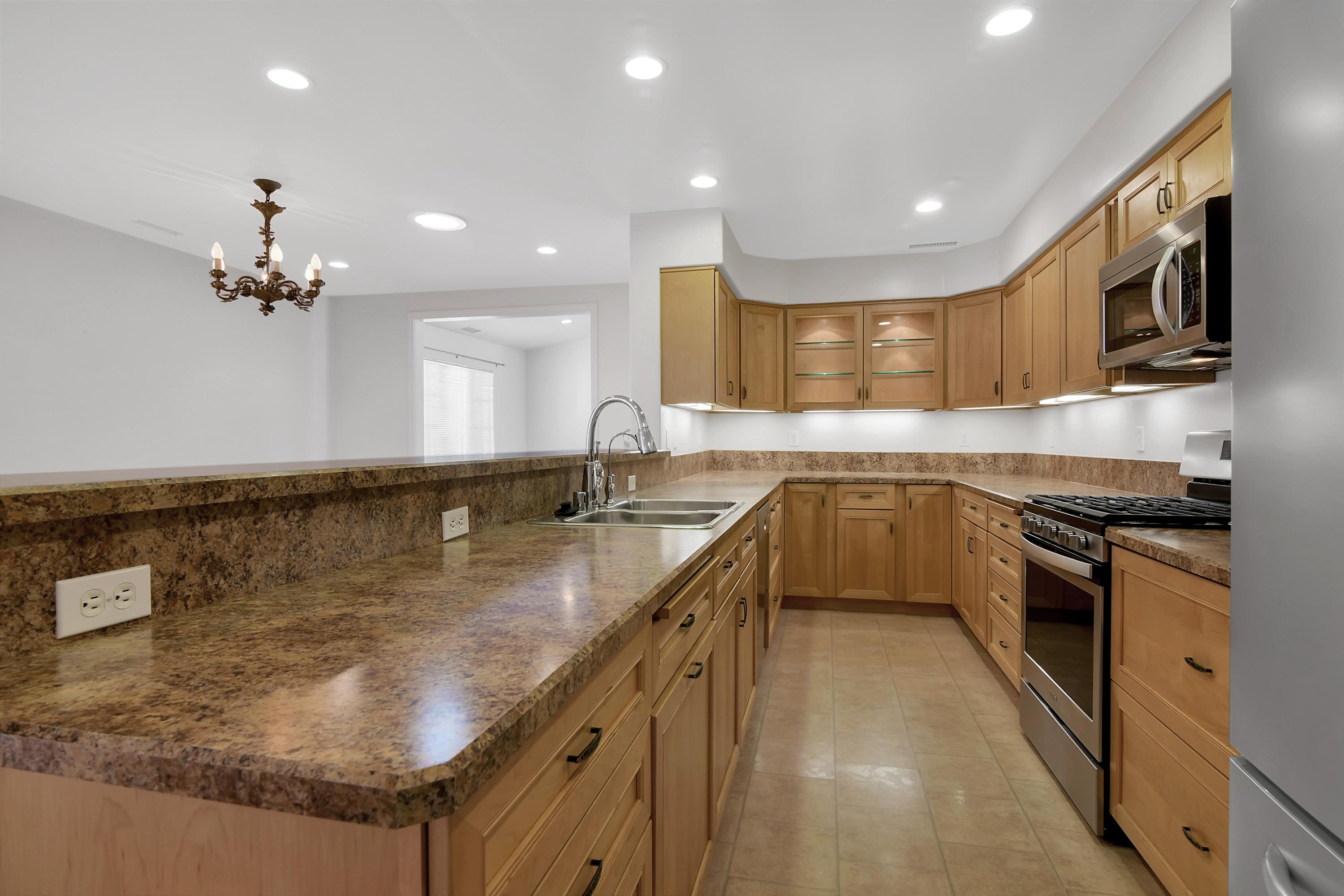 1472 Eucalyptus Street Carpinteria, CA 93013 - Photo 7 of 18 a large kitchen with stainless steel appliances granite countertop a sink a stove and a refrigerator