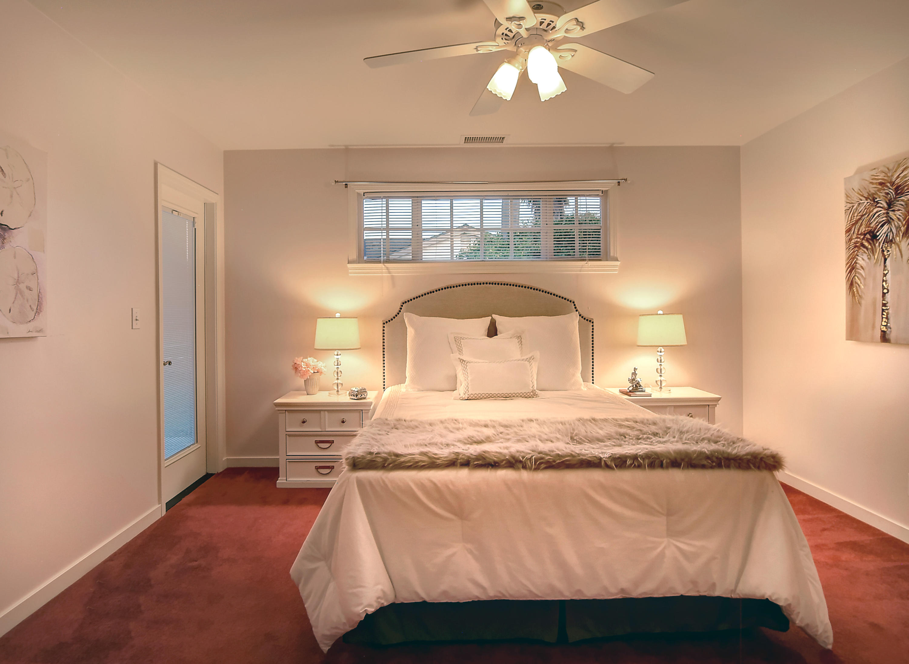 1472 Eucalyptus Street Carpinteria, CA 93013 - Photo 9 of 18 a bedroom with a bed and a chandelier