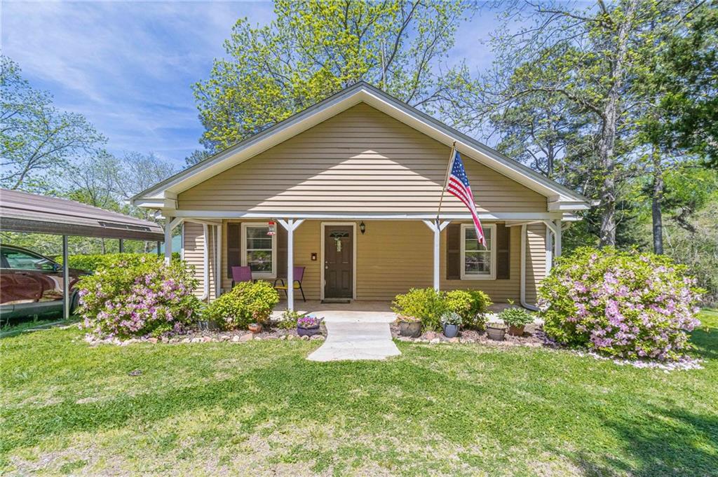 604 Pleasant Grove Road Rockmart, GA 30153 - Photo 1 of 1 a front view of a house with garden