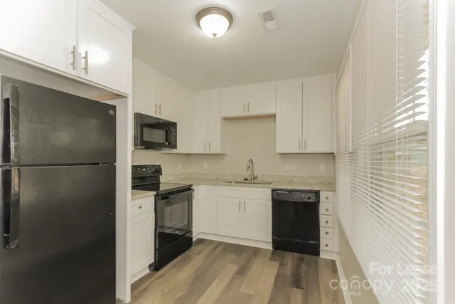 a kitchen with a sink stainless steel appliances and cabinets