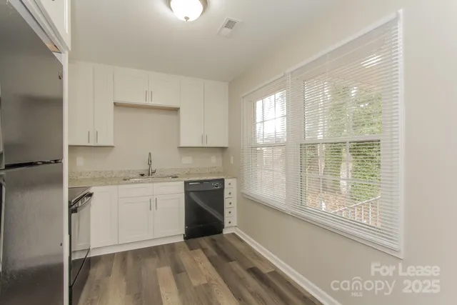 a kitchen with a sink stove and cabinets