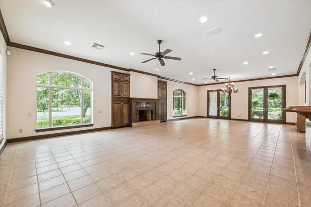 a view of an empty room with a fireplace and a large window
