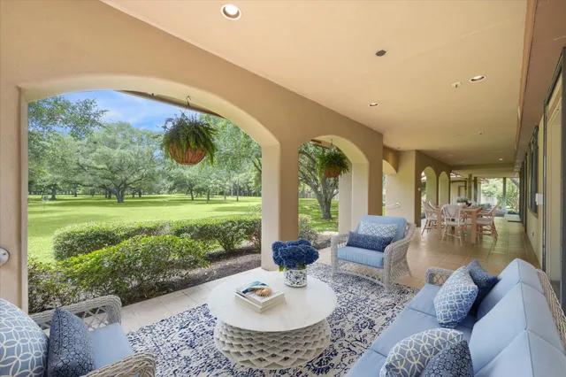 a living room with patio furniture and a large window