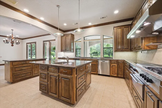 a kitchen with stainless steel appliances granite countertop a stove and a sink
