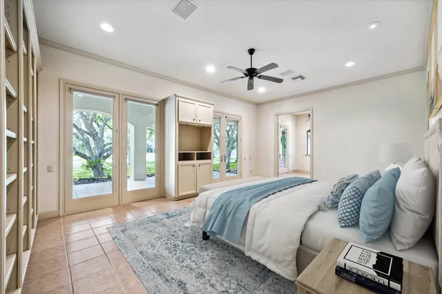 a spacious bedroom with a large bed and a chandelier