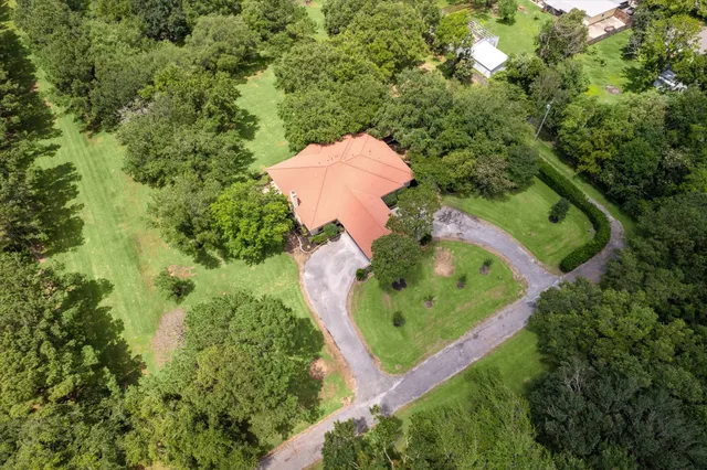 an aerial view of a house with a yard and outdoor seating