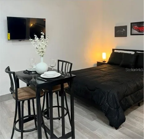 a bedroom with a bed and a flat screen tv