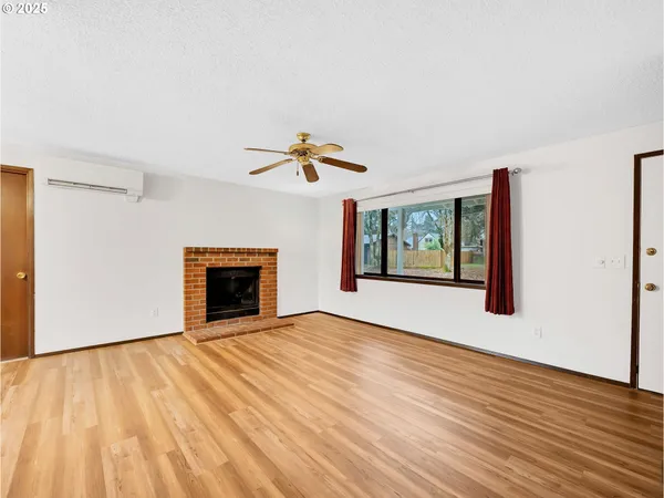 a view of an empty room with glass door and a window