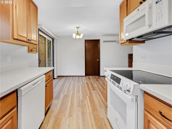 a kitchen with a sink a refrigerator and cabinets