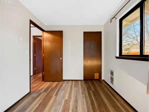 a view of a room with wooden floor and windows