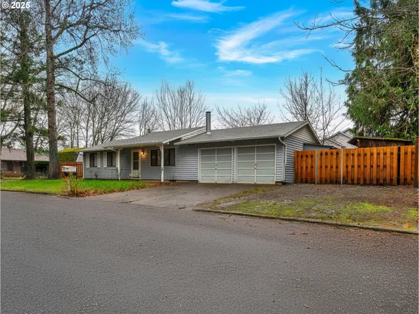 a view of a house with a yard and garage
