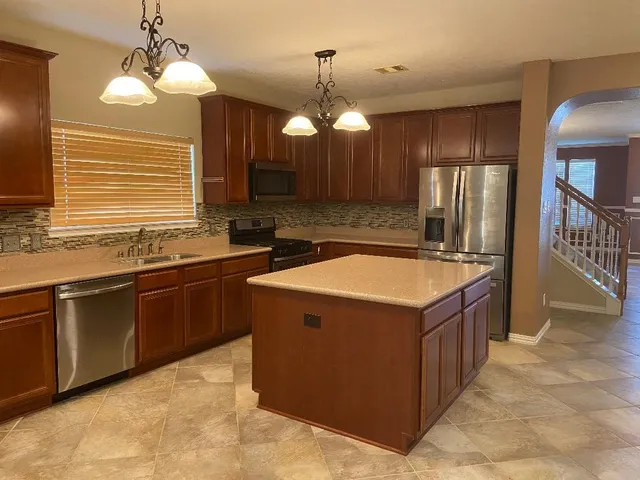 a kitchen that has a sink and a stove