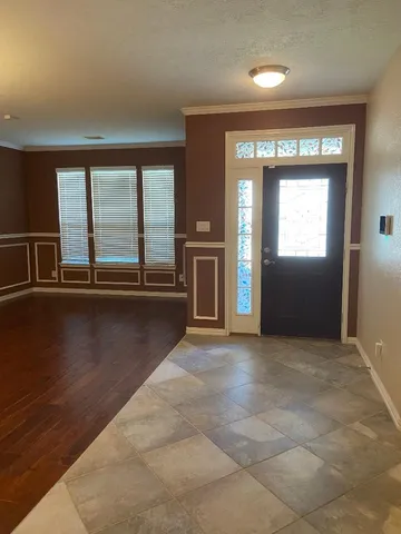 an empty room with large windows and a fireplace