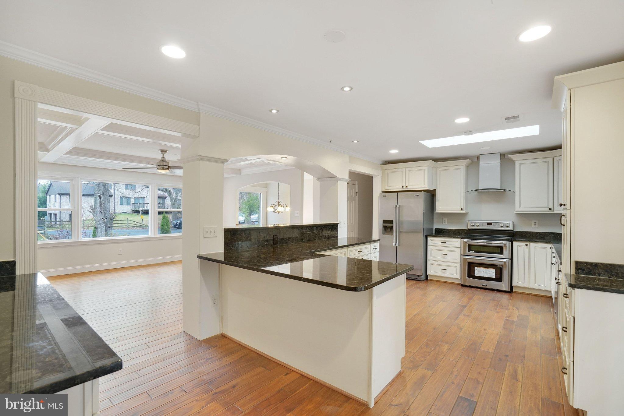3412 Knox Road Annandale, VA 22003 - Photo 13 of 54 a kitchen with stainless steel appliances granite countertop a refrigerator a sink a stove and a wooden floors