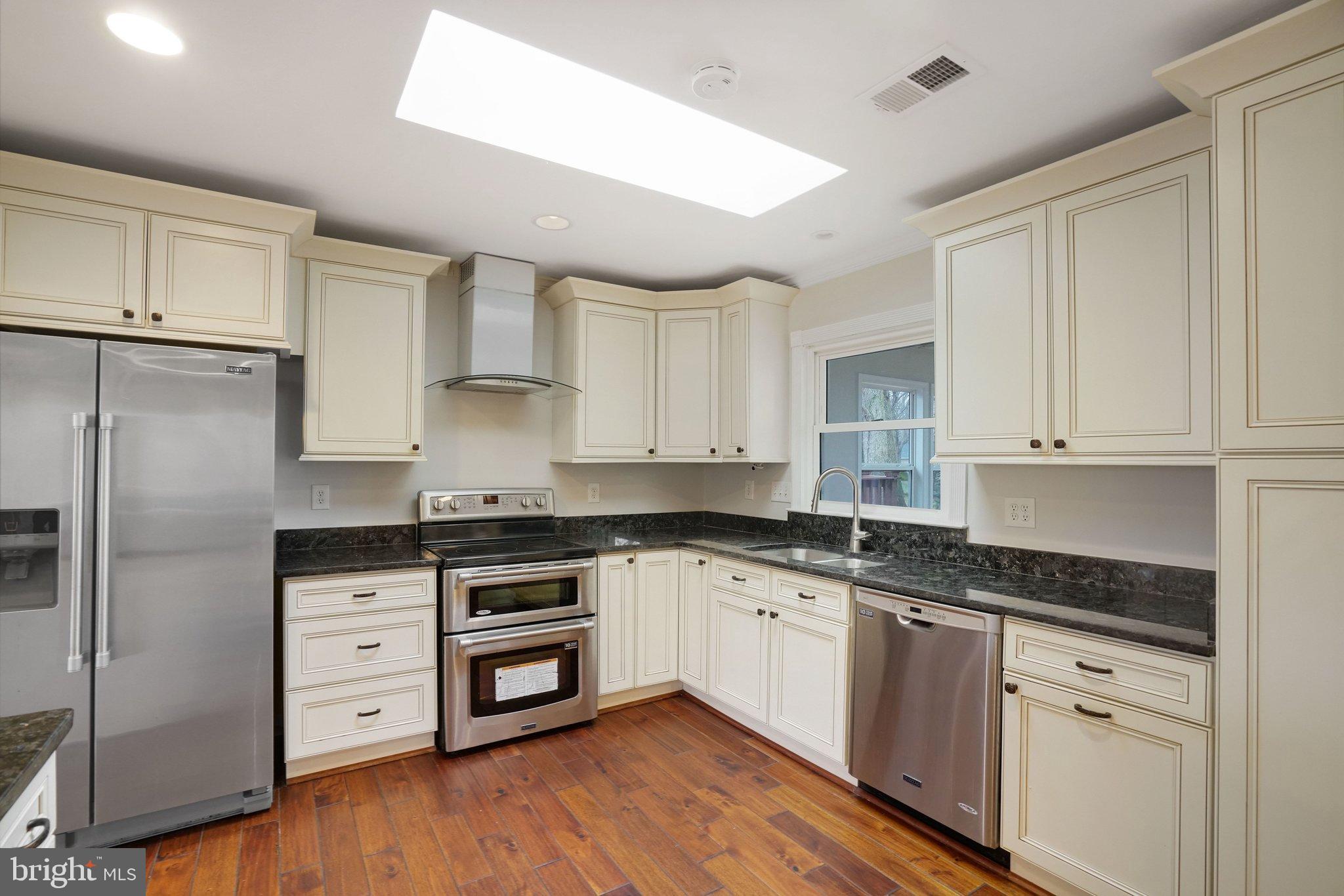 3412 Knox Road Annandale, VA 22003 - Photo 15 of 54 a kitchen with stainless steel appliances granite countertop a stove a sink and white cabinets