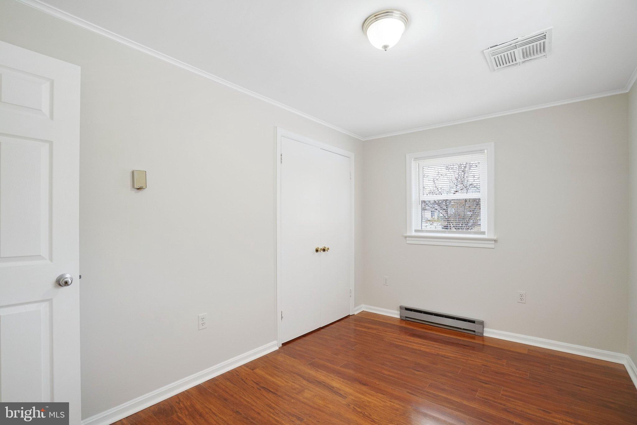 3412 Knox Road Annandale, VA 22003 - Photo 43 of 54 an empty room with wooden floor and windows