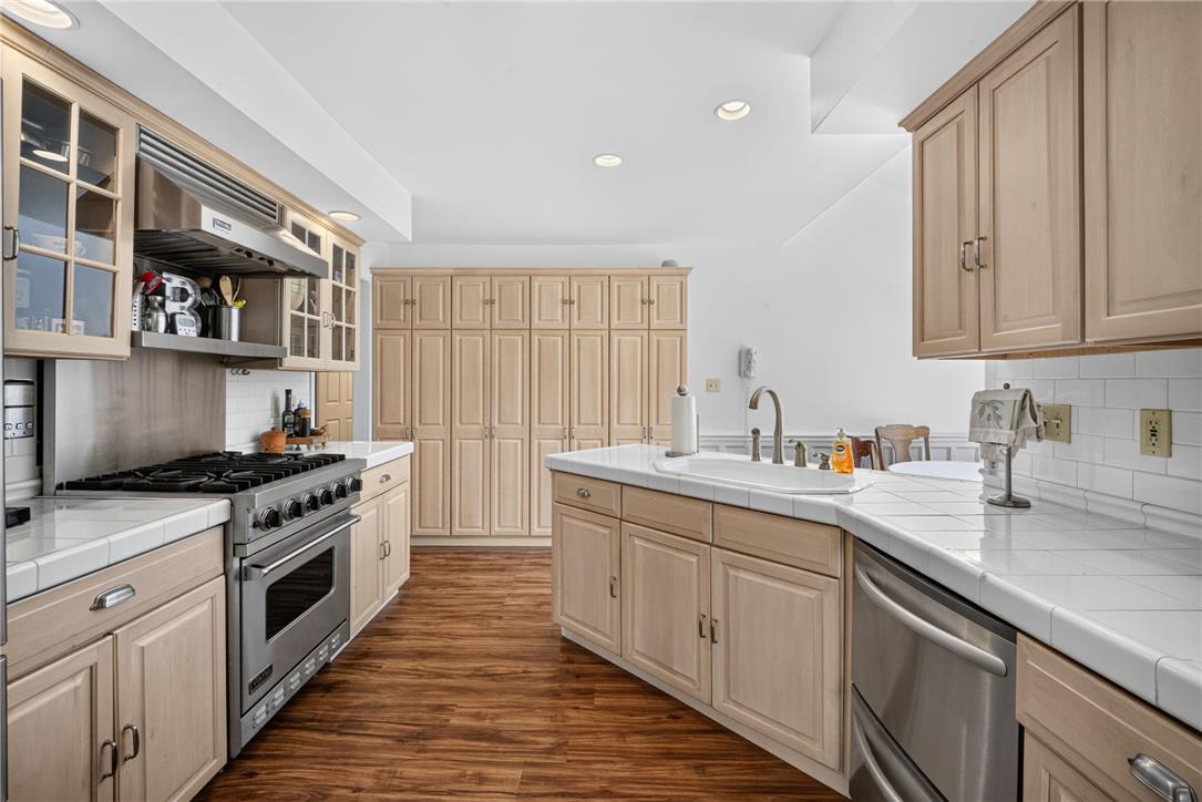 6467 Abbey Road Wind Gap, PA 18091 - Photo 15 of 46 Warm wood cabinetry and durable tile counters create a highly functional kitchen space.