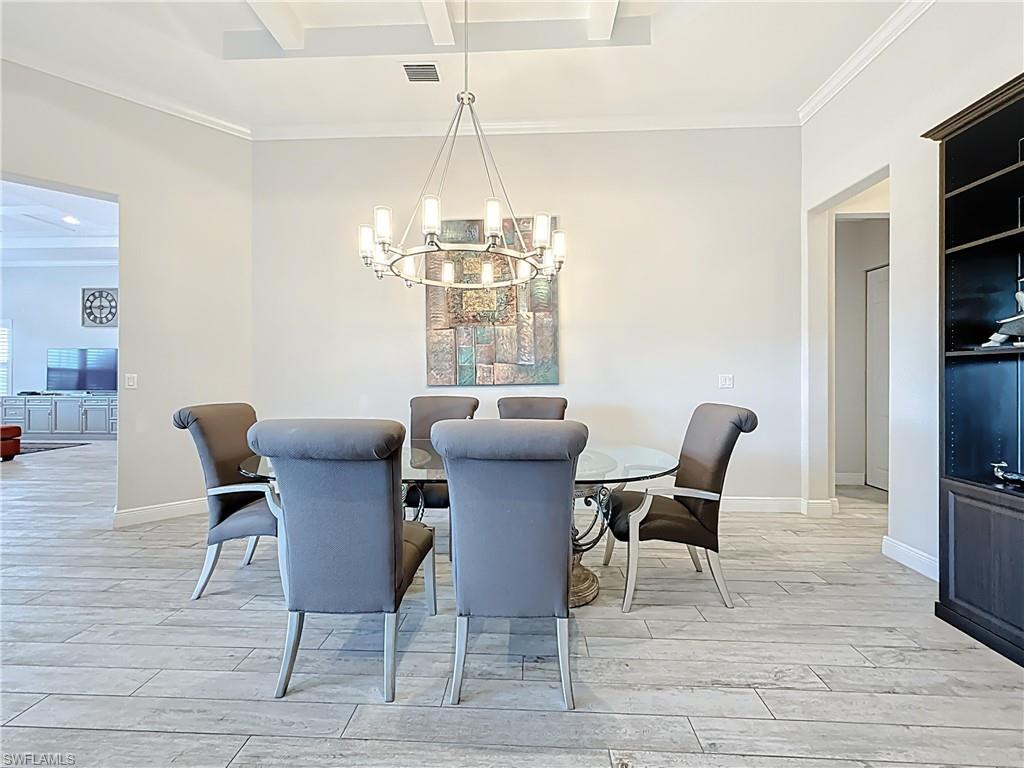 5550 Ferrari Avenue Ave Maria, FL 34142 - Photo 11 of 50 a view of a dining room with furniture wooden floor and a chandelier