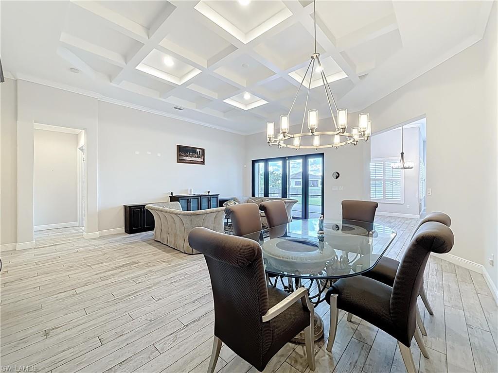 5550 Ferrari Avenue Ave Maria, FL 34142 - Photo 12 of 50 a view of a dining room with furniture and chandelier