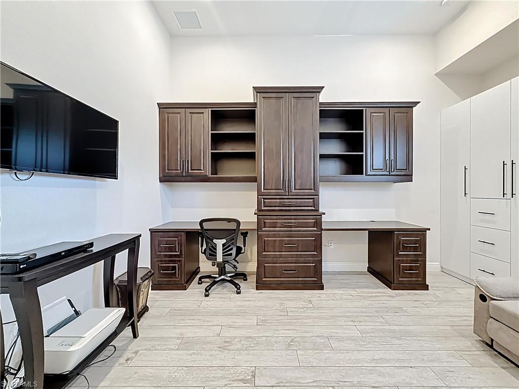 5550 Ferrari Avenue Ave Maria, FL 34142 - Photo 14 of 50 a view of living room kitchen with stainless steel appliances cabinets and flat screen tv