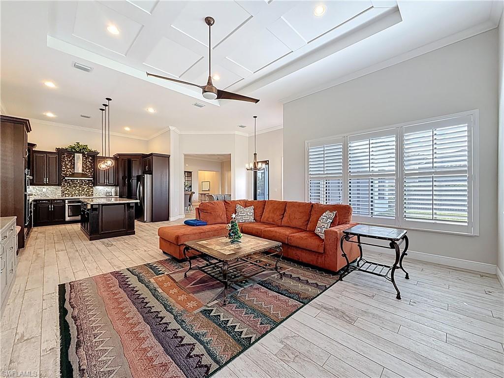5550 Ferrari Avenue Ave Maria, FL 34142 - Photo 16 of 50 a living room with furniture kitchen view and a wooden floor