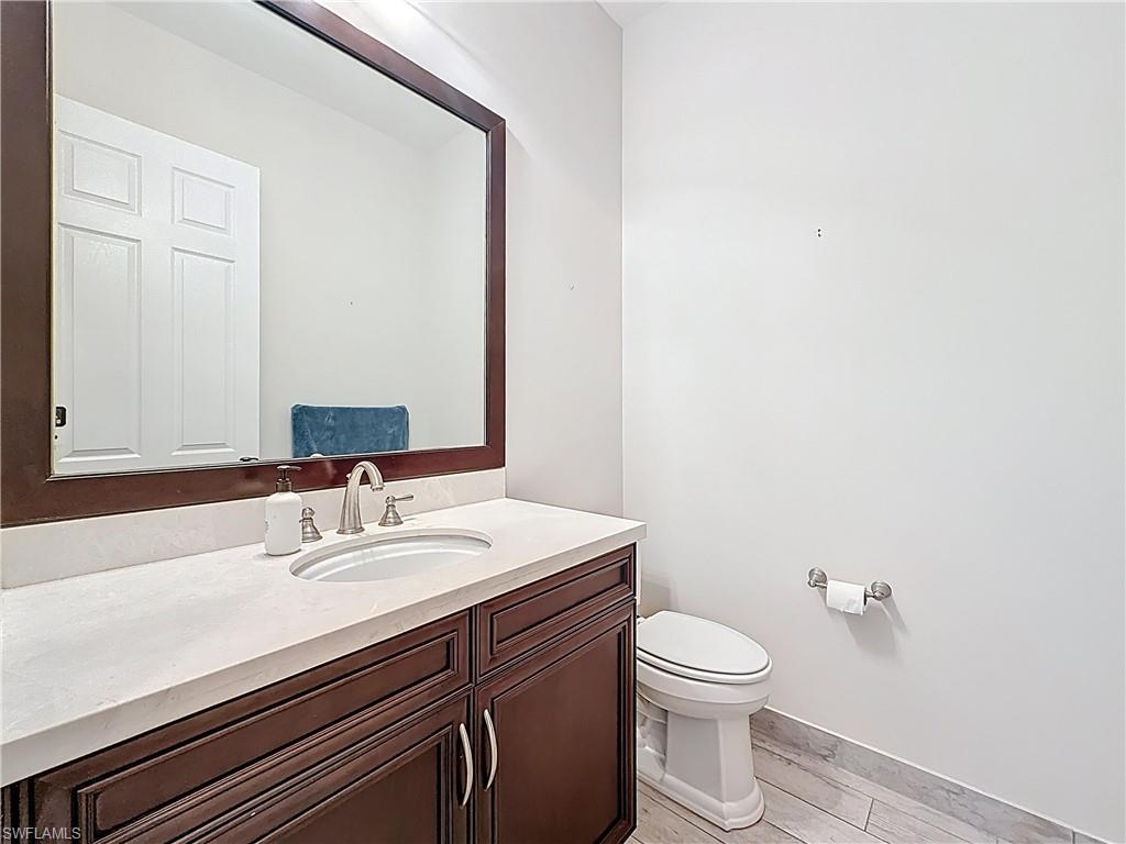 5550 Ferrari Avenue Ave Maria, FL 34142 - Photo 19 of 50 a bathroom with a sink a toilet and mirror