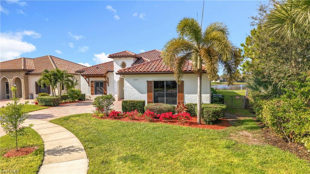 5550 Ferrari Avenue Ave Maria, FL 34142 - Photo 2 of 50 a front view of house with yard