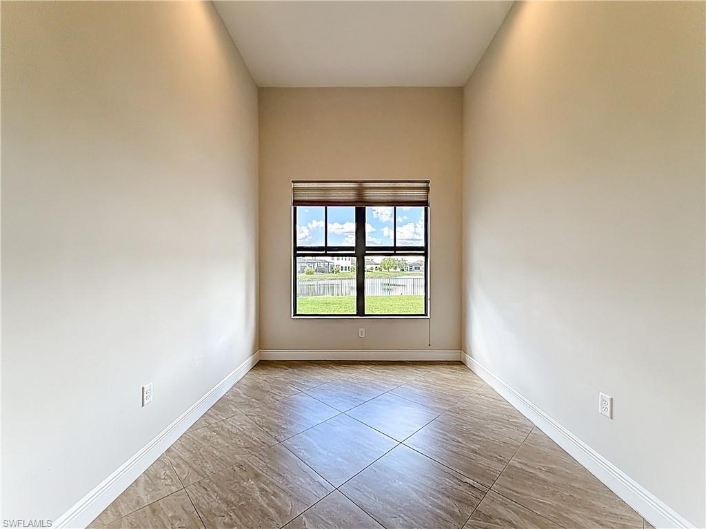 5550 Ferrari Avenue Ave Maria, FL 34142 - Photo 24 of 50 an empty room with wooden floor and windows