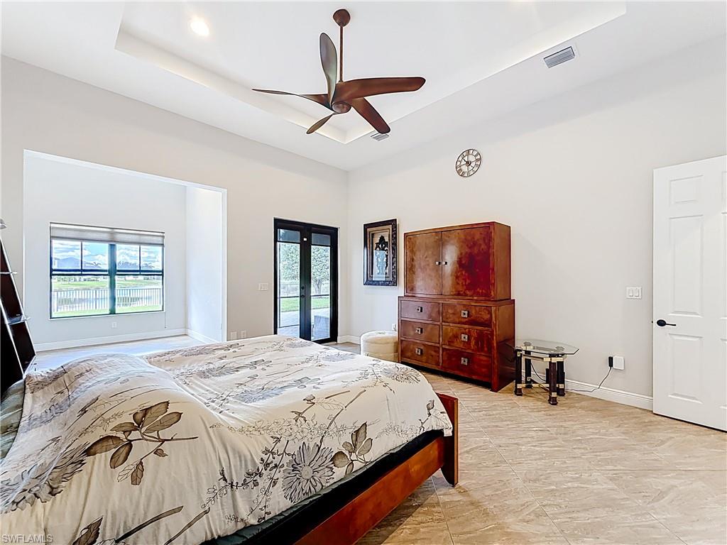 5550 Ferrari Avenue Ave Maria, FL 34142 - Photo 26 of 50 a spacious bedroom with a bed and a flat screen tv