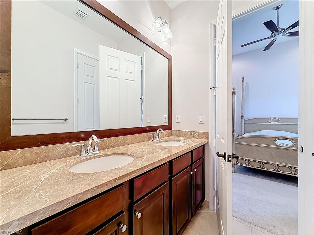 5550 Ferrari Avenue Ave Maria, FL 34142 - Photo 34 of 50 a en suite bathroom with a granite countertop sink and a mirror