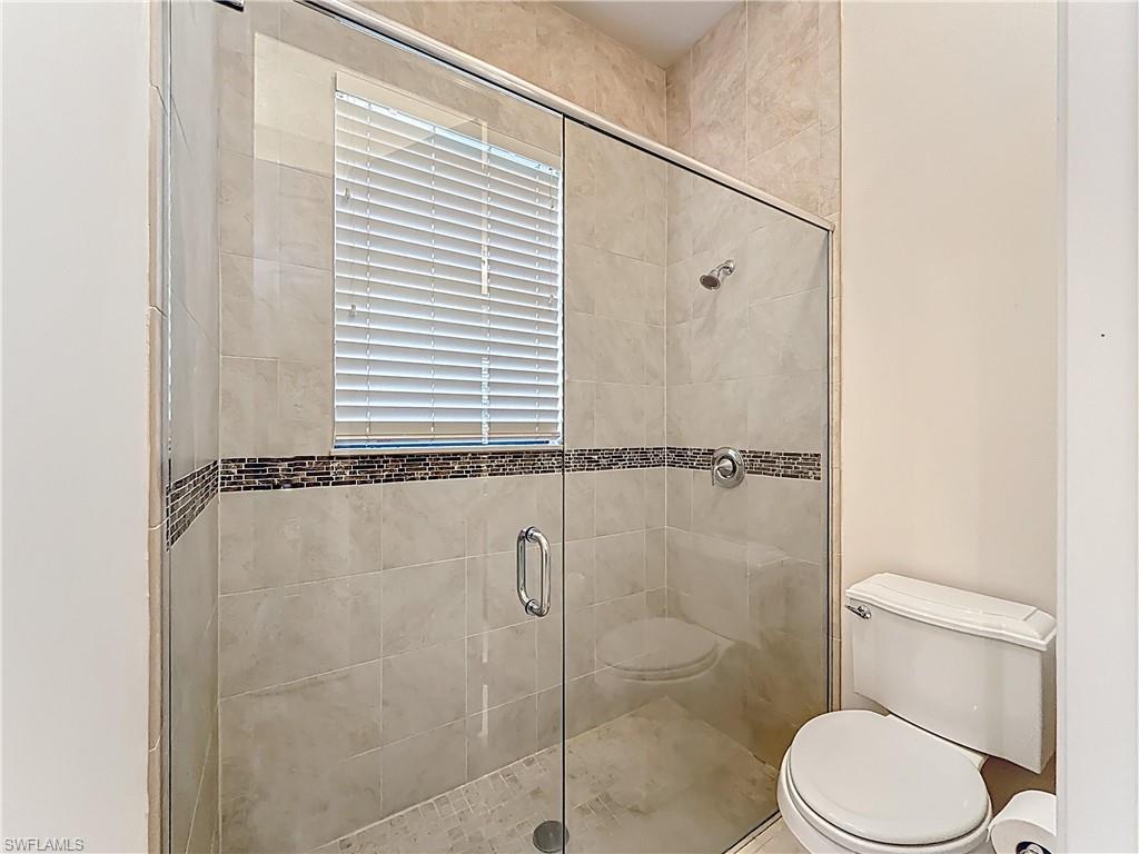 5550 Ferrari Avenue Ave Maria, FL 34142 - Photo 35 of 50 a white toilet sitting next to a bath tub and shower