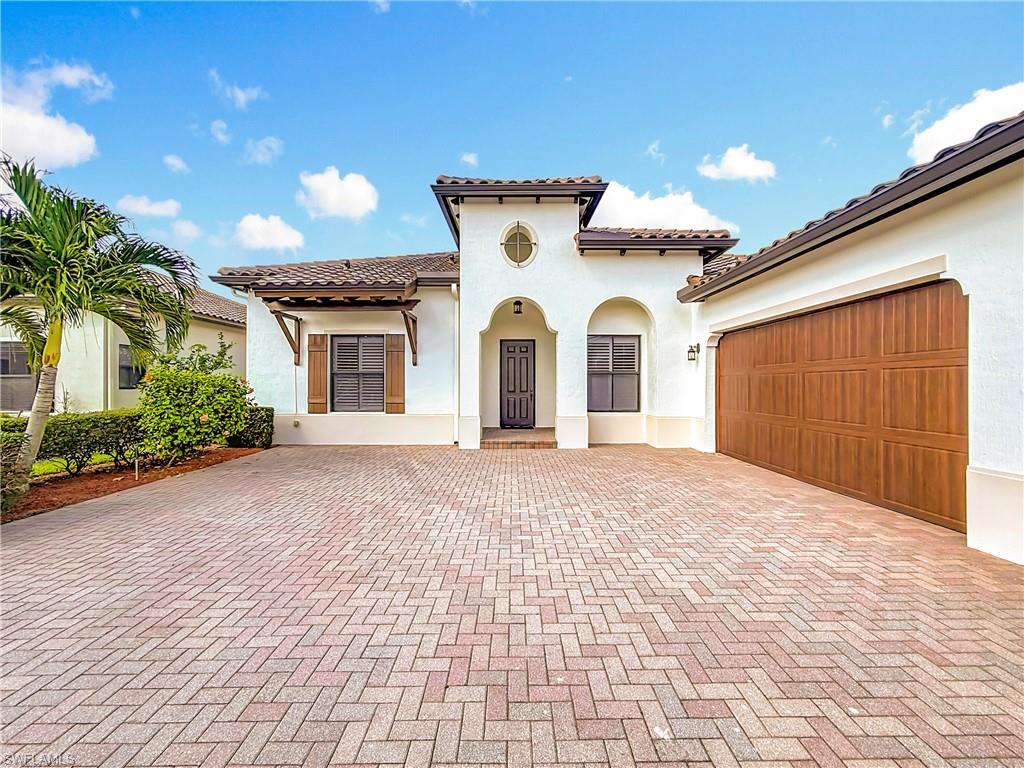 5550 Ferrari Avenue Ave Maria, FL 34142 - Photo 4 of 50 a view of a white house with a yard and potted plants
