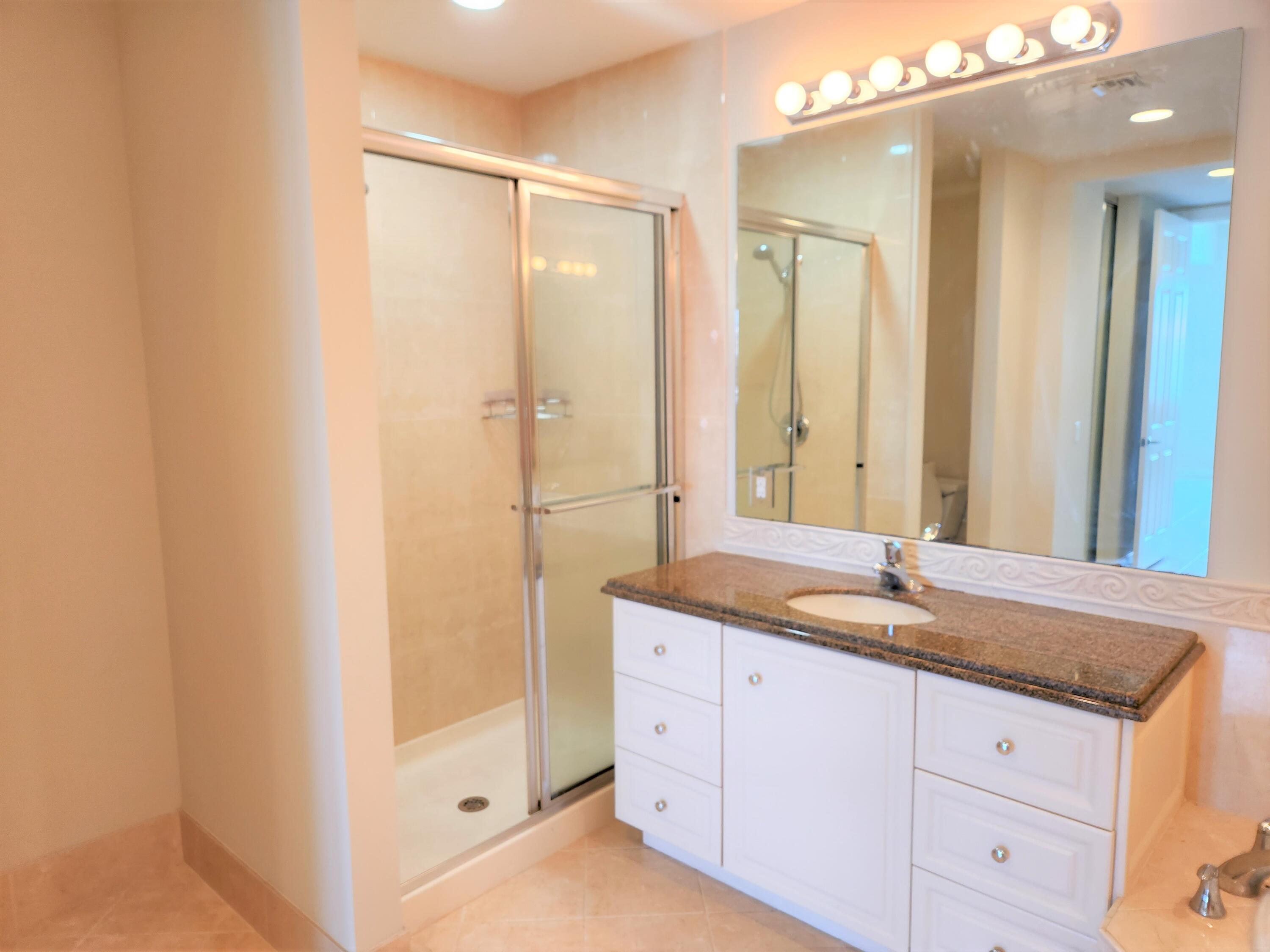10 Harbour Isle Drive East, Unit 303 Fort Pierce, FL 34949 - Photo 12 of 31 a bathroom with a granite countertop sink mirror and double