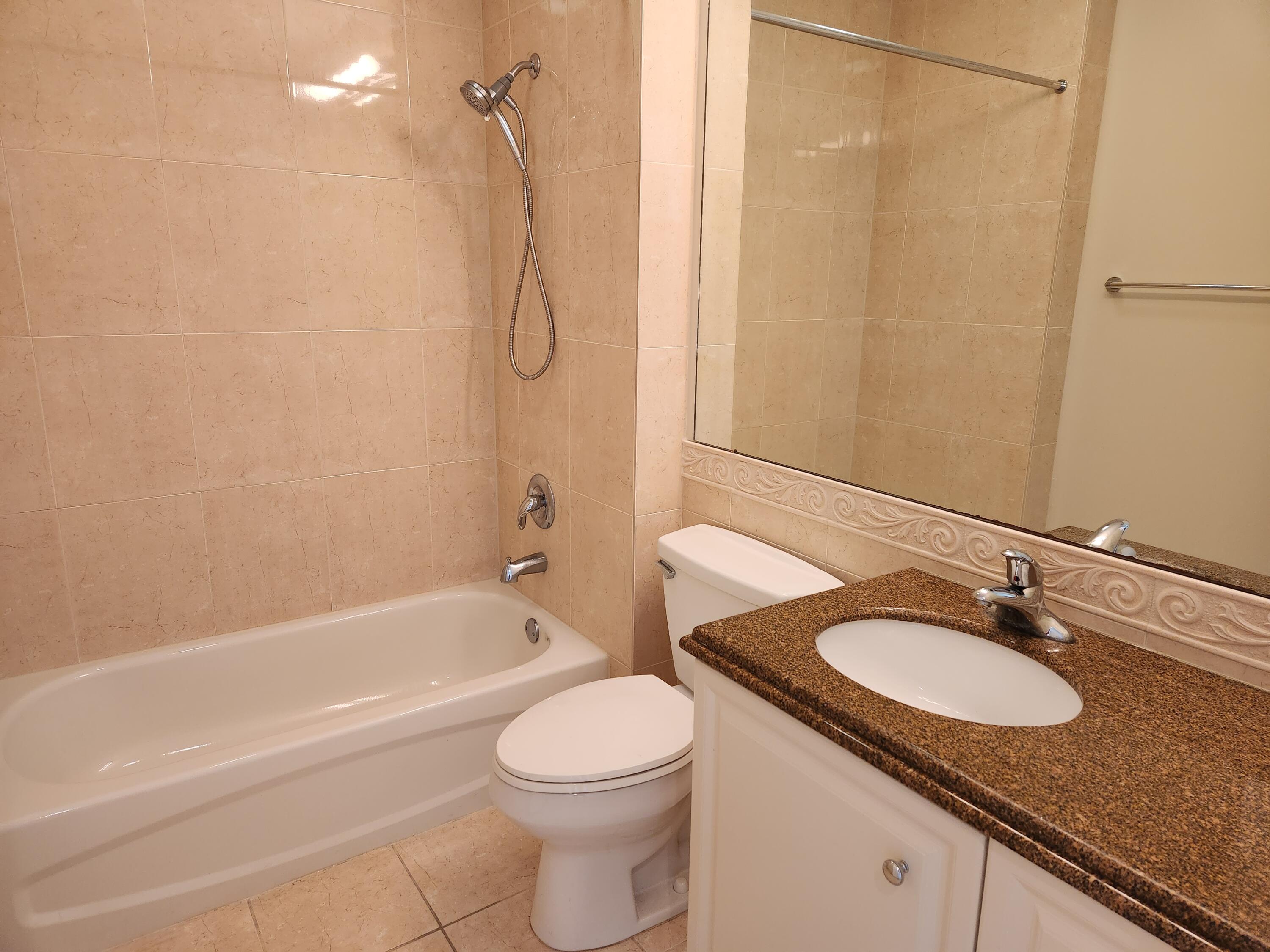 10 Harbour Isle Drive East, Unit 303 Fort Pierce, FL 34949 - Photo 17 of 31 a bathroom with a granite countertop sink toilet and shower