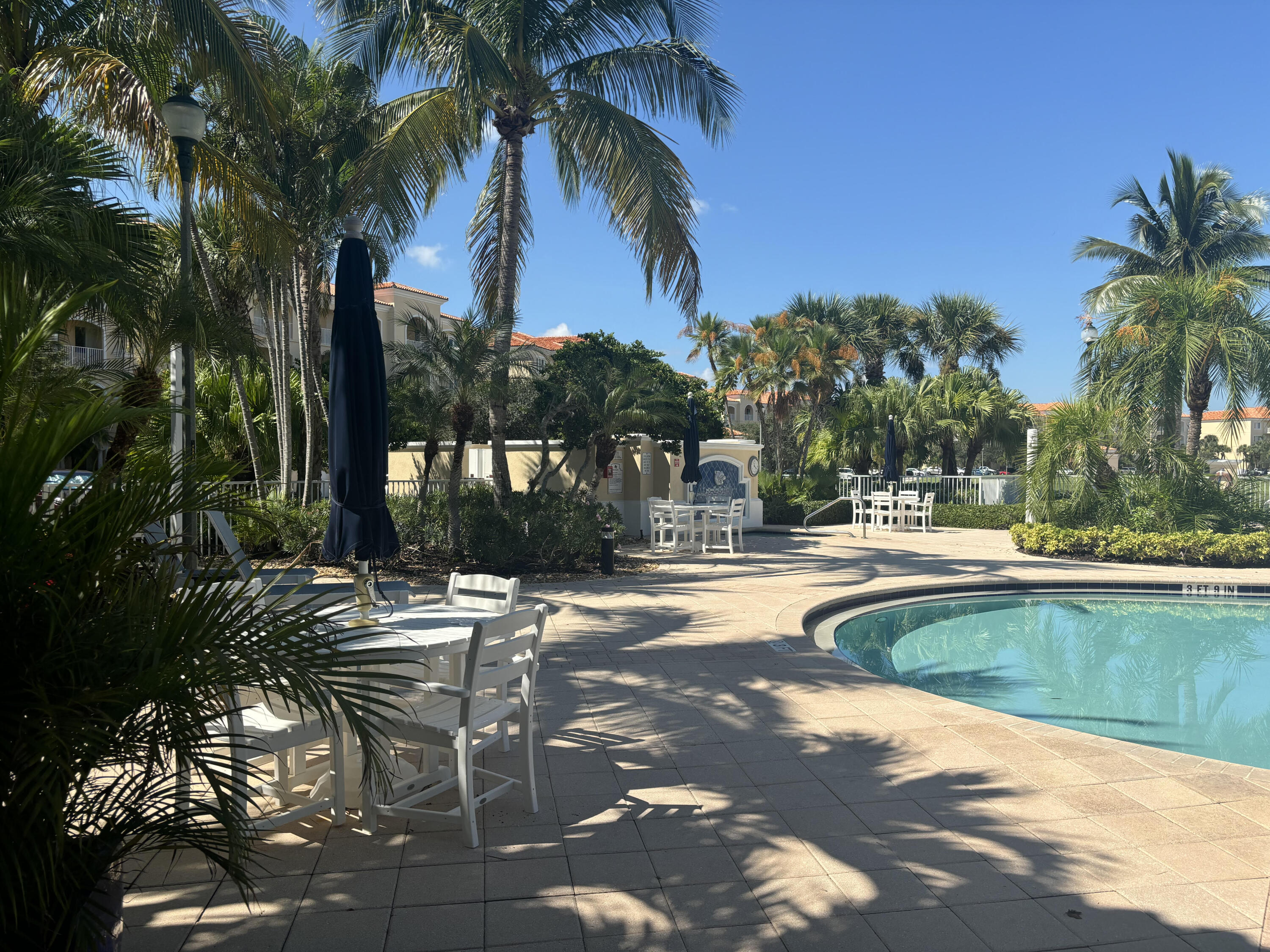 10 Harbour Isle Drive East, Unit 303 Fort Pierce, FL 34949 - Photo 20 of 31 a view of swimming pool with outdoor seating and plants