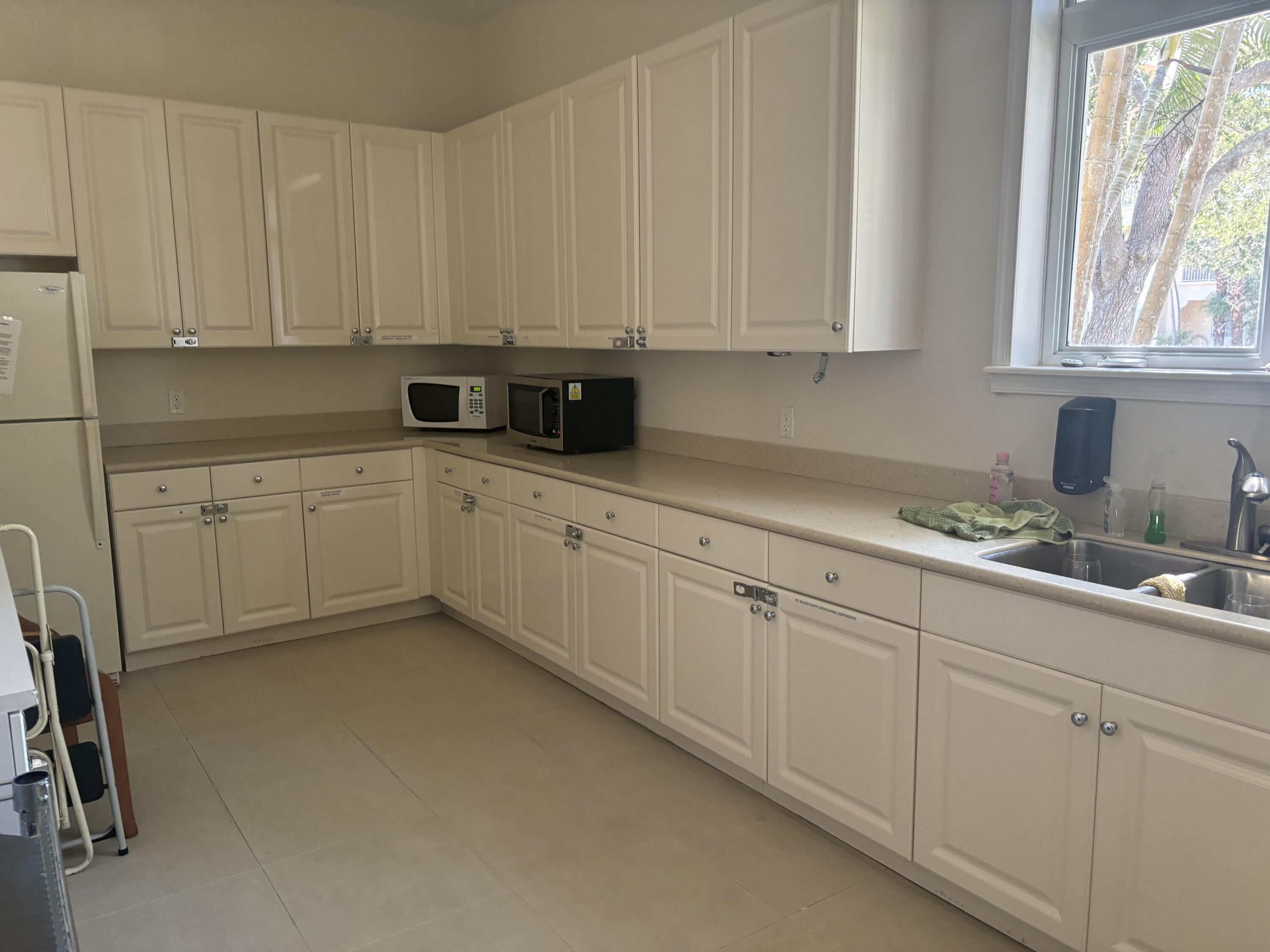 10 Harbour Isle Drive East, Unit 303 Fort Pierce, FL 34949 - Photo 27 of 31 a kitchen with white cabinets and white appliances