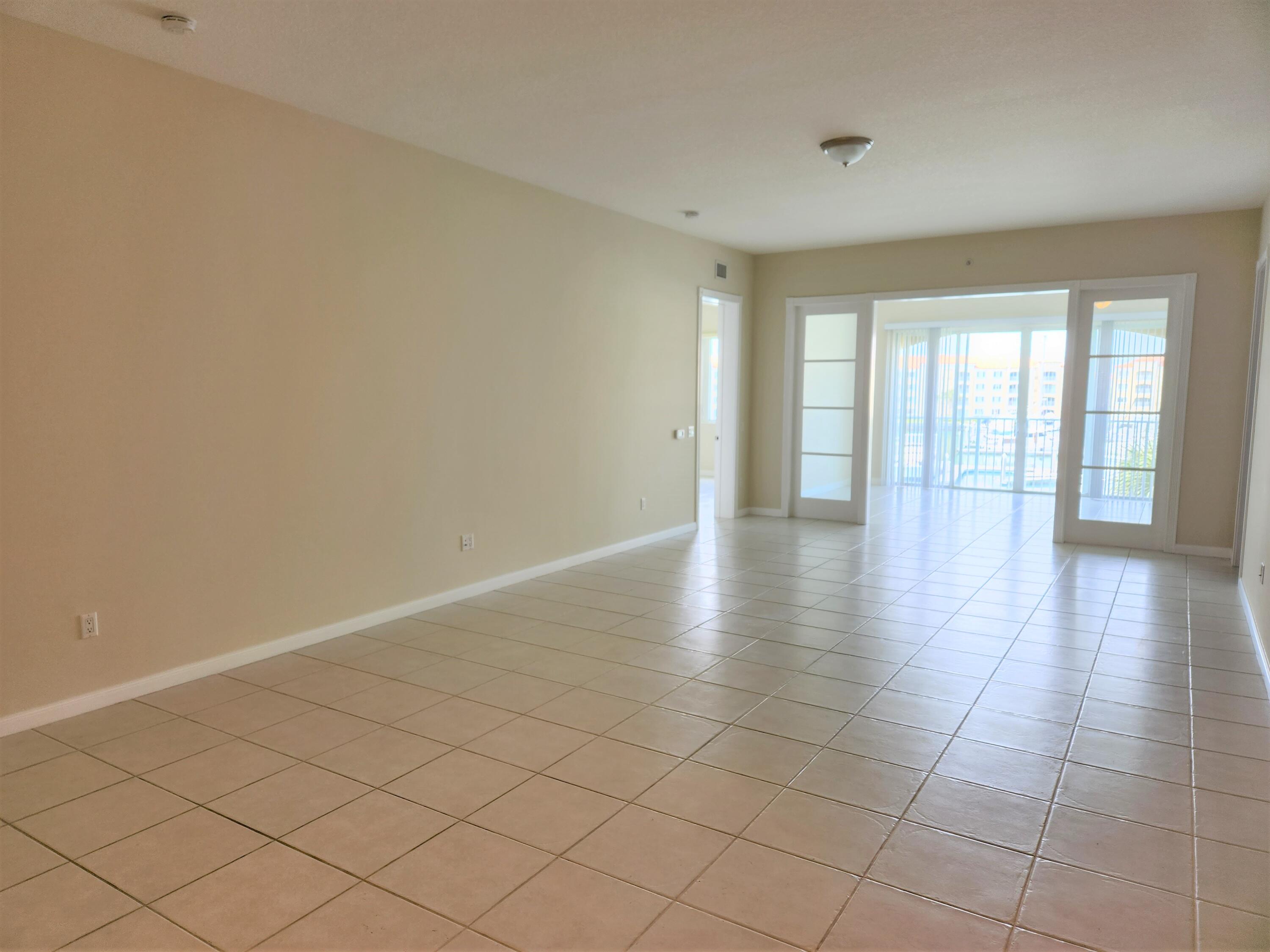 10 Harbour Isle Drive East, Unit 303 Fort Pierce, FL 34949 - Photo 4 of 31 wooden floor in an empty room with a window