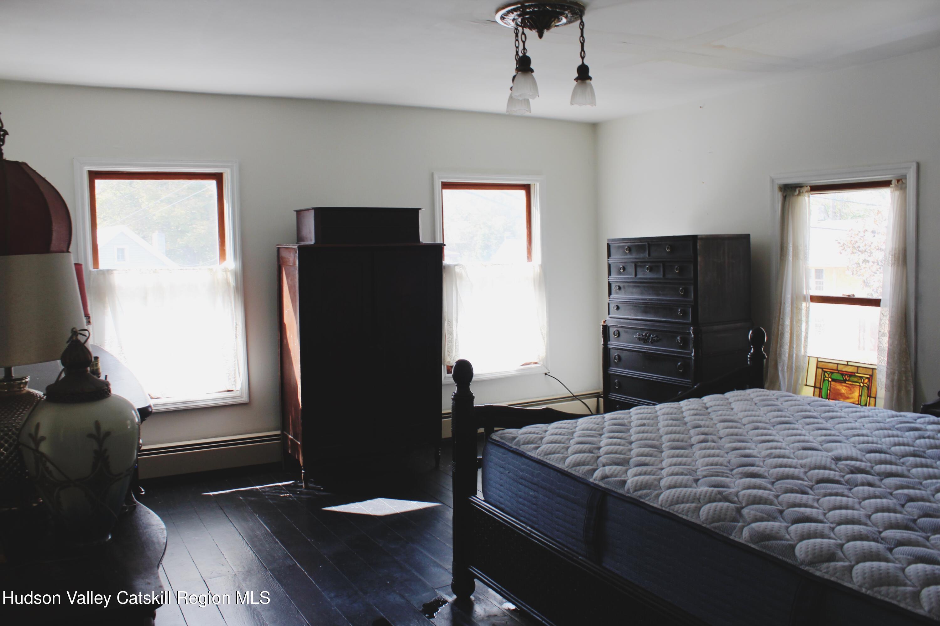 564 Main Street Cairo, NY 12413 - Photo 11 of 27 a bedroom with a bed and a dresser