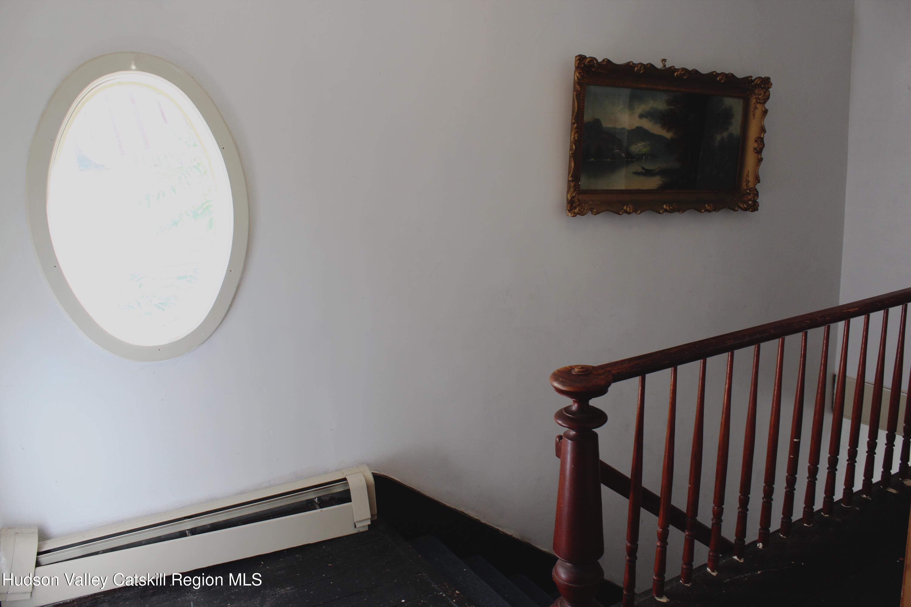 564 Main Street Cairo, NY 12413 - Photo 16 of 27 a view of a hallway with wooden floor and a mirror