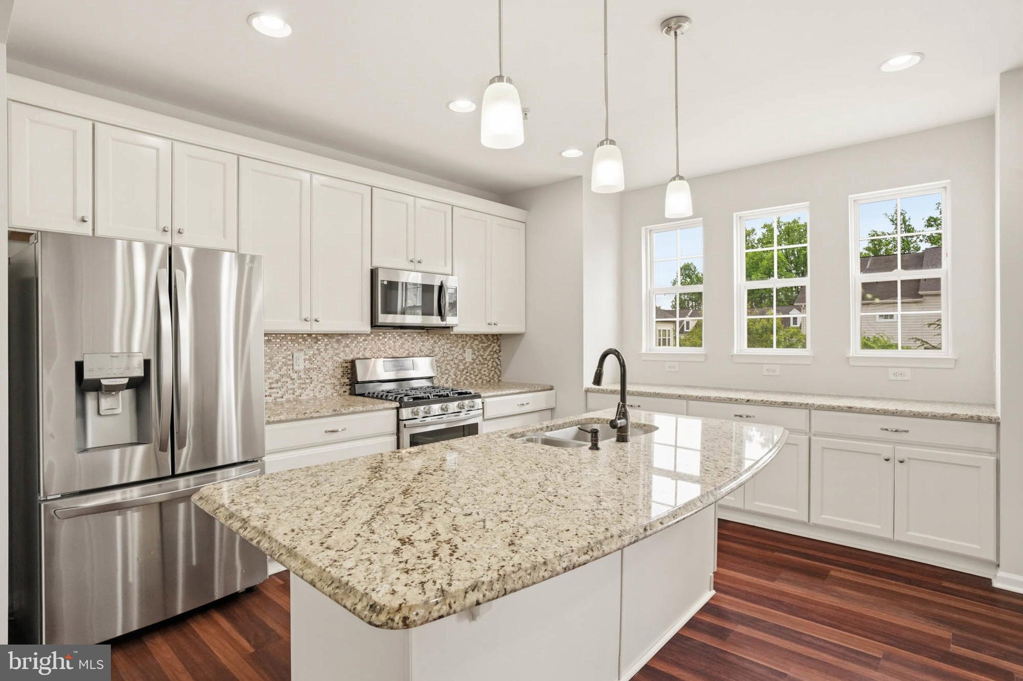 9817 Solar Course Laurel, MD 20723 - Photo 5 of 59 a kitchen with stainless steel appliances granite countertop a sink refrigerator and microwave