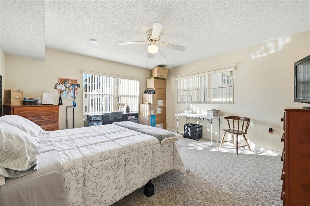 110 North Tremain Street, Unit 109 Mount Dora, FL 32757 - Photo 18 of 45 a bedroom with a bed a couch and dresser