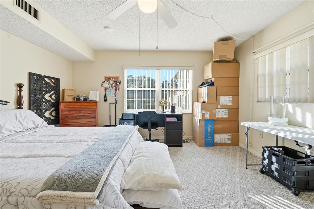 110 North Tremain Street, Unit 109 Mount Dora, FL 32757 - Photo 20 of 45 a bedroom with a bed and furniture