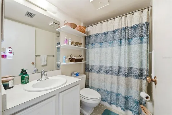 a bedroom that has a bed and a table in it